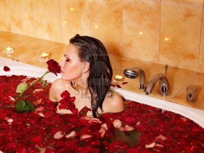 9899437-woman-relaxing-in-bath-with-rose-petal.jpg