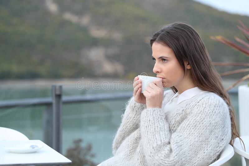 serious-girl-drinking-coffee-looking-away-terrace-pensive-lake-170812749.jpg