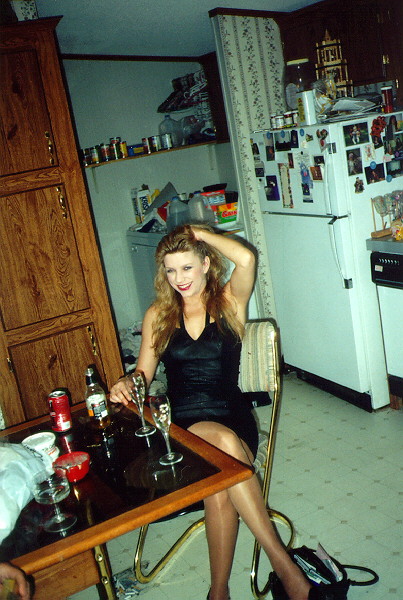 Sitting at Kitchen table in a black mini-dress laughing Mg013.jpg