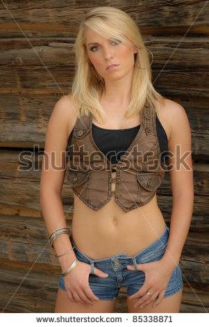 stock-photo-sexy-blonde-cowgirl-wearing-vest-and-jean-shorts-85338871.jpg