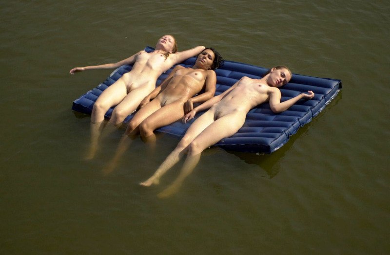 Three-naked-young-chicks-tanning-in-the-middle-of-the-lake.jpg